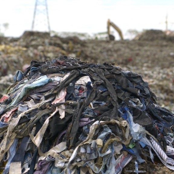 pile of clothes in the landfill